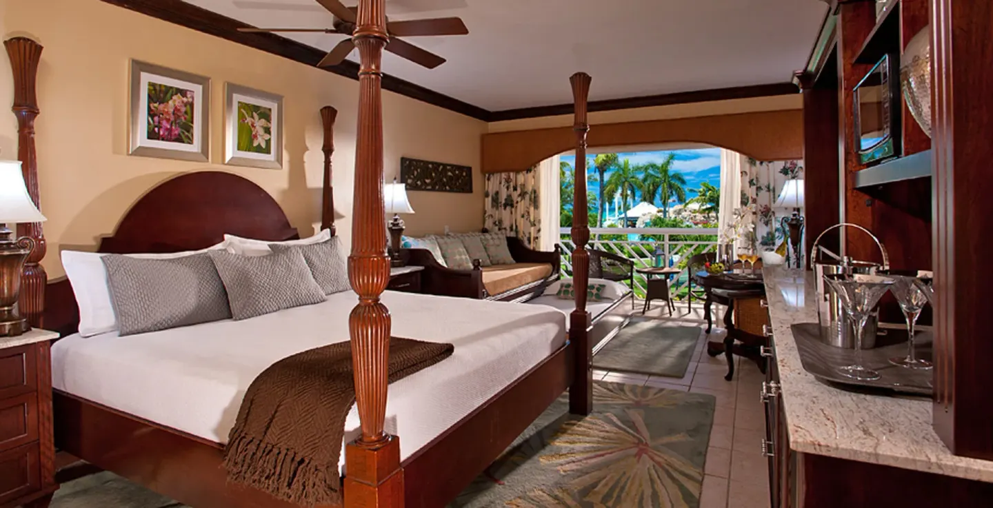 Caribbean Honeymoon Luxury Concierge Suite bedroom with four-poster bed at Beaches Turks & Caicos.