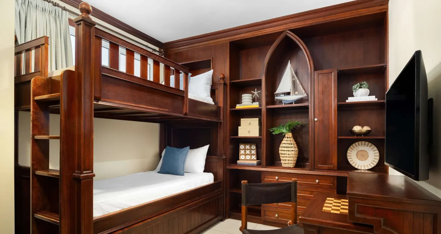 Wooden bunk beds and built-in desk in a family suite kids room at Beaches Turks & Caicos.