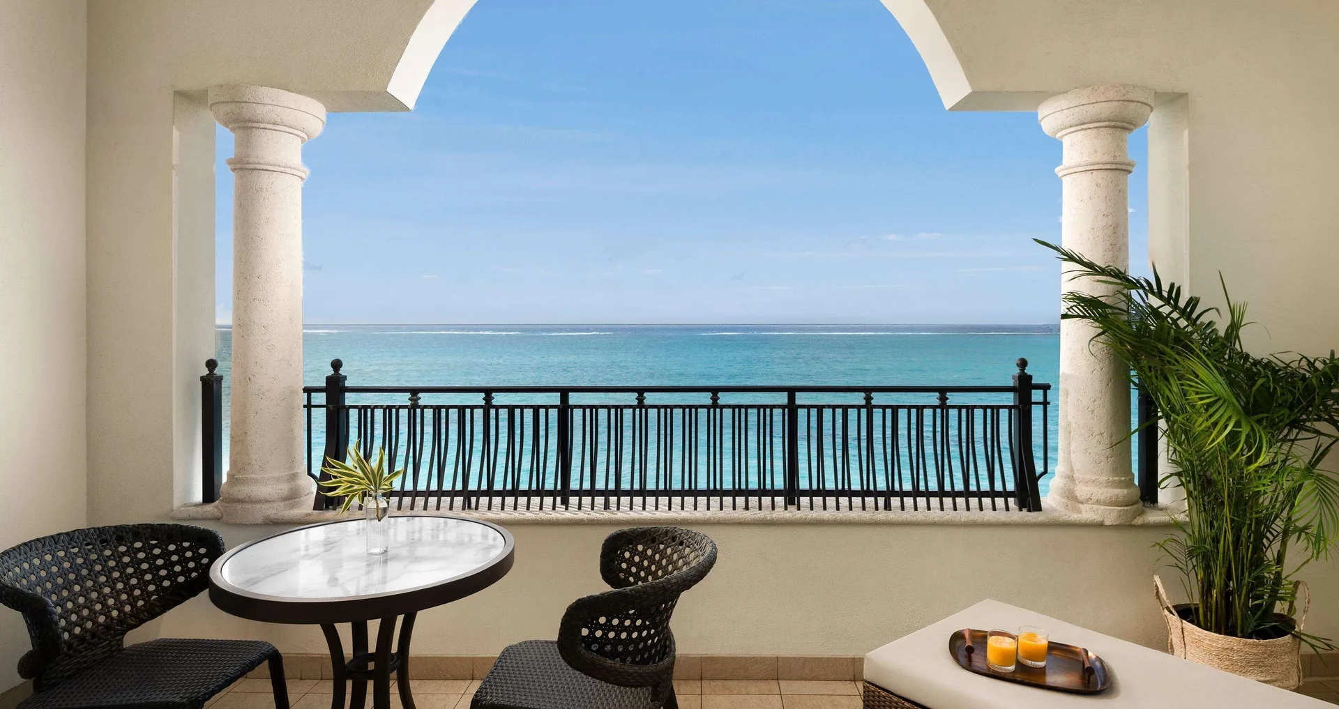 Ocean-view suite balcony with seating at Beaches Turks & Caicos.