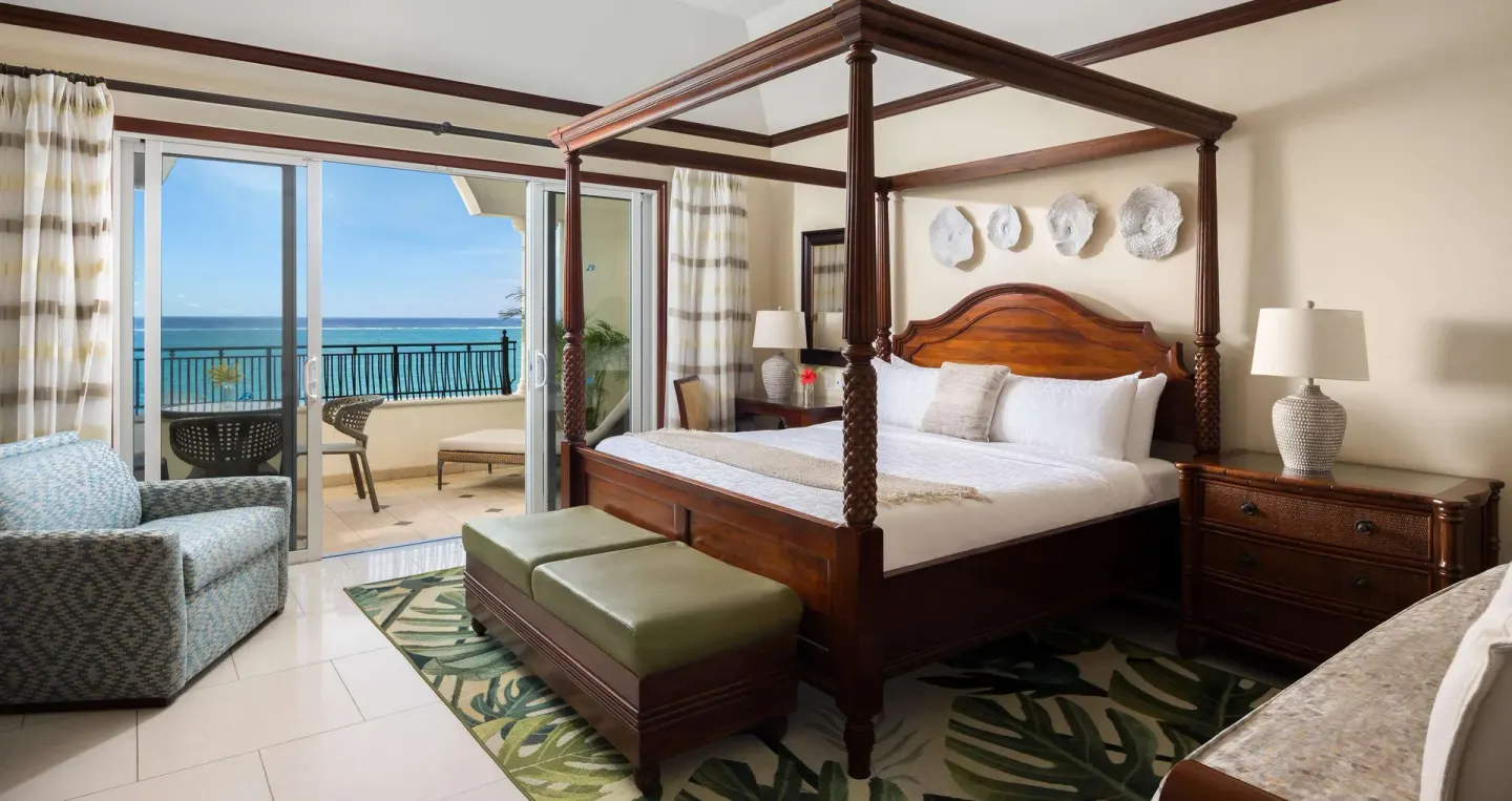 Family Suite bedroom with four-poster bed and ocean balcony at Beaches Turks & Caicos.