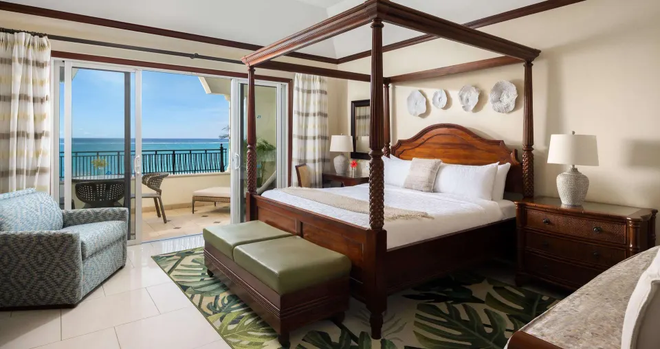 Ocean-view Family Suite bedroom with four-poster bed at Beaches Turks & Caicos.