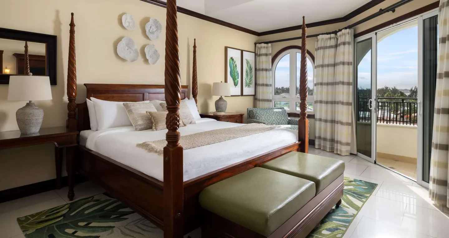 Ocean-view family suite bedroom with four-poster king bed at Beaches Turks & Caicos.