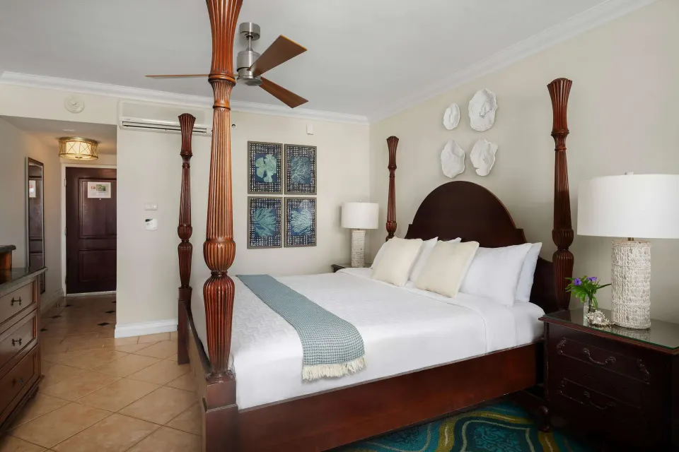 Four-poster king bed in a Luxury Room at Beaches Turks & Caicos with nightstands and tile floor.