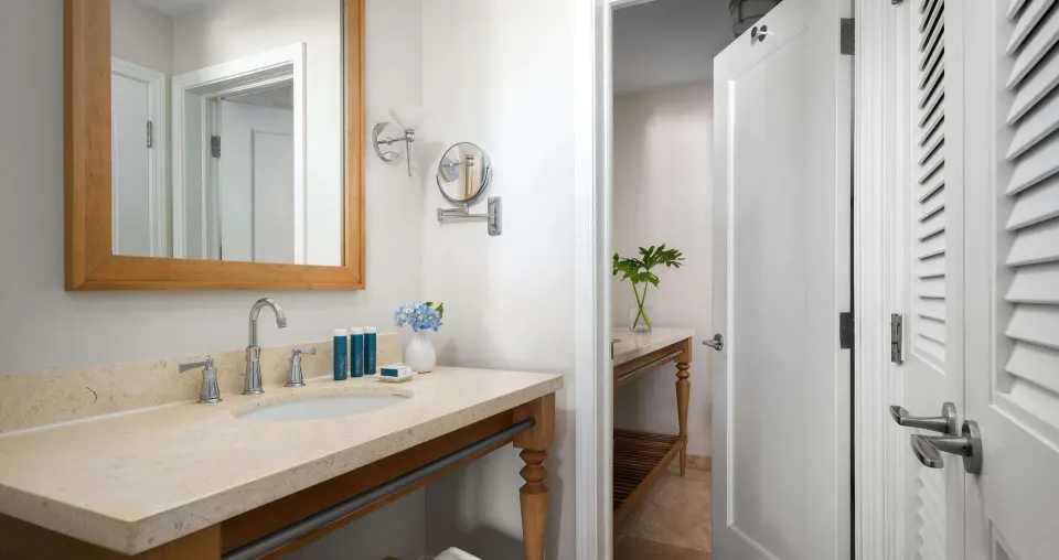 Stone bathroom vanity and open dressing area door at Beaches Turks & Caicos.