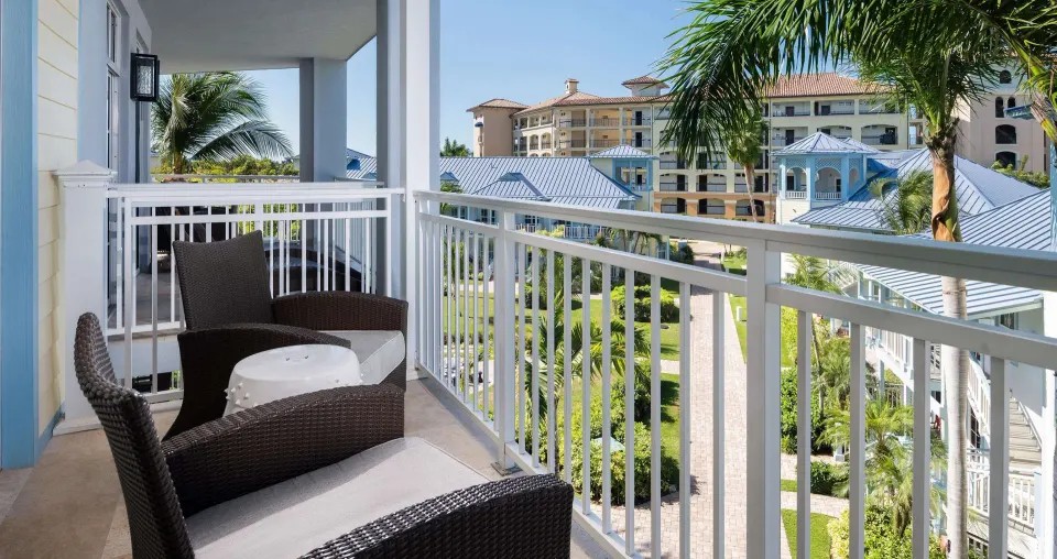 Furnished balcony with garden and resort building views at Beaches Turks & Caicos.
