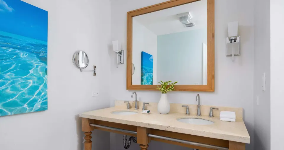 Bathroom vanity with twin sinks and coastal artwork at Beaches Turks & Caicos.