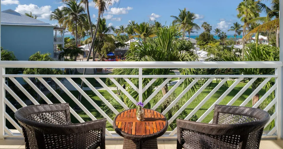 Garden-view balcony at Beaches Turks & Caicos with two chairs and a small table.