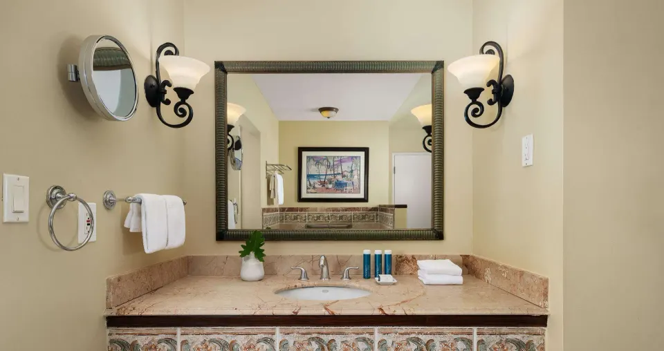 Bathroom vanity with marble counter and wall mirror at Beaches Turks & Caicos.