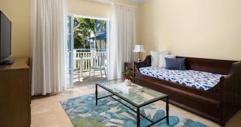 Garden view one-bedroom suite living area with daybed at Beaches Turks & Caicos.