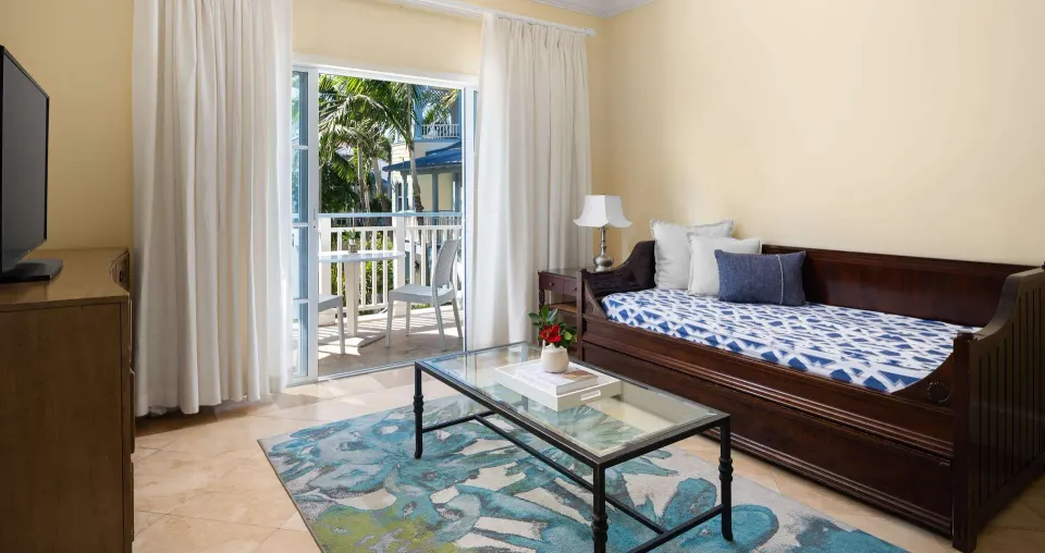 Garden view one-bedroom suite living area with daybed at Beaches Turks & Caicos.