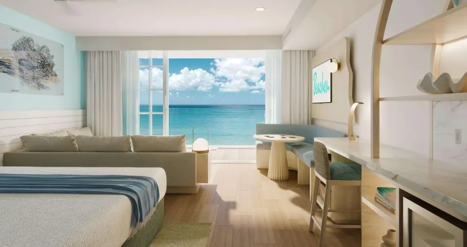 Ocean-view king bedroom suite with seating and desk at Beaches Turks & Caicos.