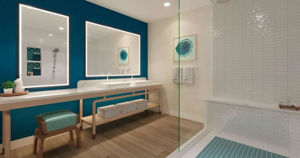 Treasure Beach Concierge suite bath with lit mirrors and tiled shower at Beaches Turks & Caicos.