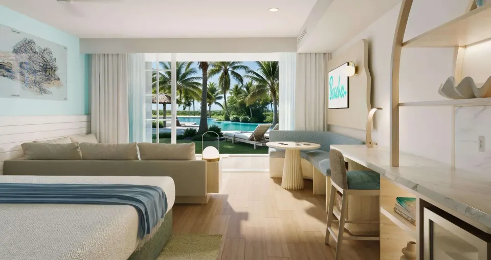 Walkout concierge suite with king bed and patio view at Beaches Turks & Caicos.