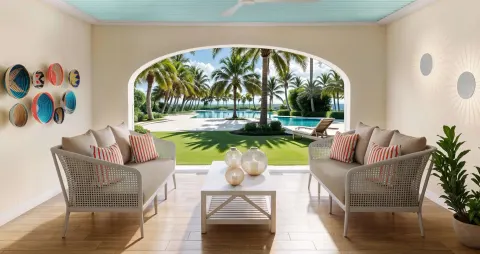 Covered walkout patio with sofas facing palms and pool at Beaches Turks & Caicos.