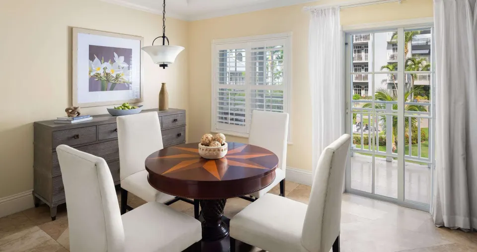 Dining area with round table and balcony doors at Beaches Turks & Caicos.