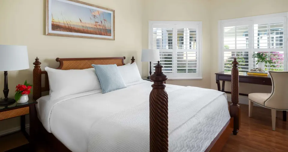 Bedroom with four-poster king bed and desk at Beaches Turks & Caicos.
