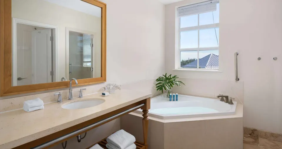 Ocean-view suite bathroom with vanity and soaking tub at Beaches Turks & Caicos.
