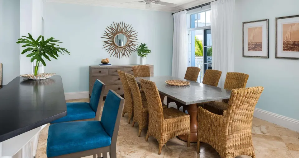 Ocean-view suite dining room with wicker chairs at Beaches Turks & Caicos.
