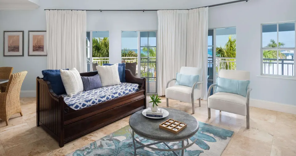 Ocean-view suite living area with daybed and balcony at Beaches Turks & Caicos.