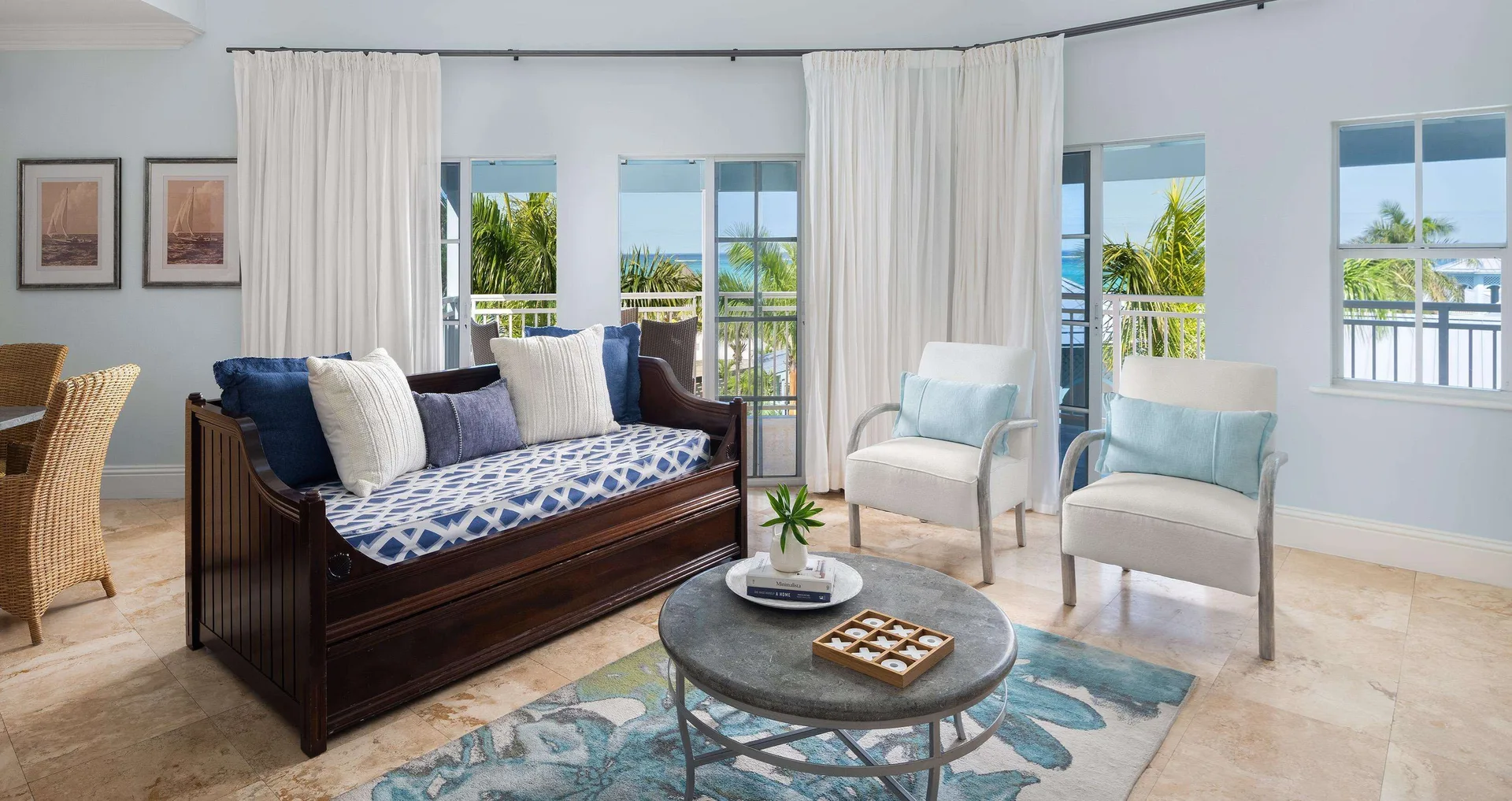 Ocean-view suite living area with daybed and balcony at Beaches Turks & Caicos.