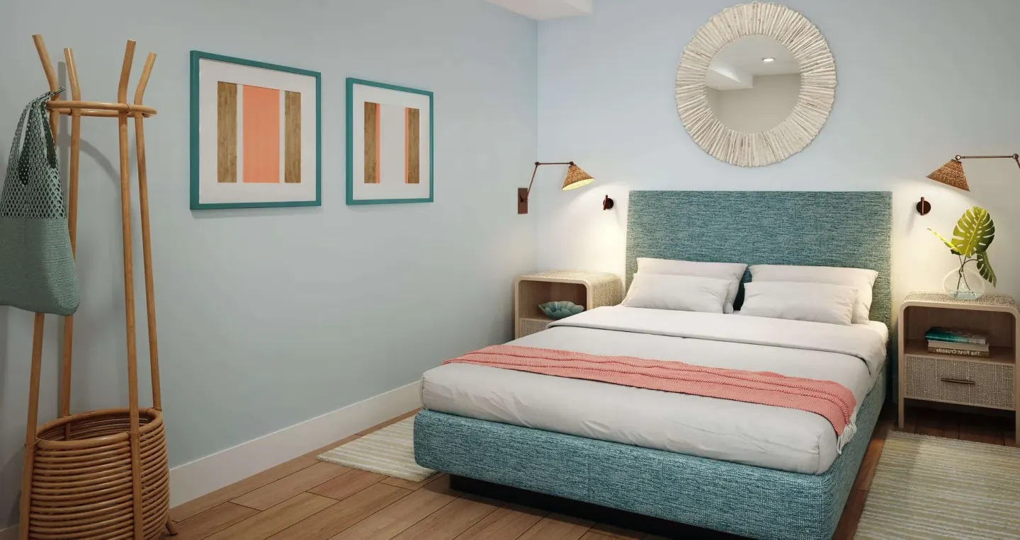 King bedroom in a two-bedroom ocean-view suite at Beaches Turks & Caicos with teal headboard and wall mirror.