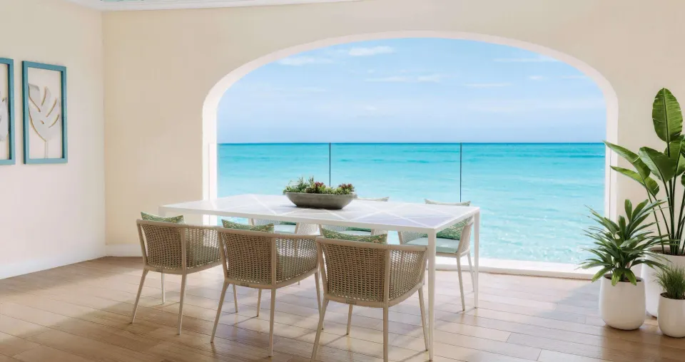 Covered ocean-view terrace at Beaches Turks & Caicos with dining table and turquoise water beyond.