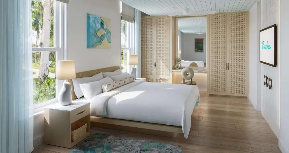 Villa king bedroom with tall windows and wardrobes at Beaches Turks & Caicos.