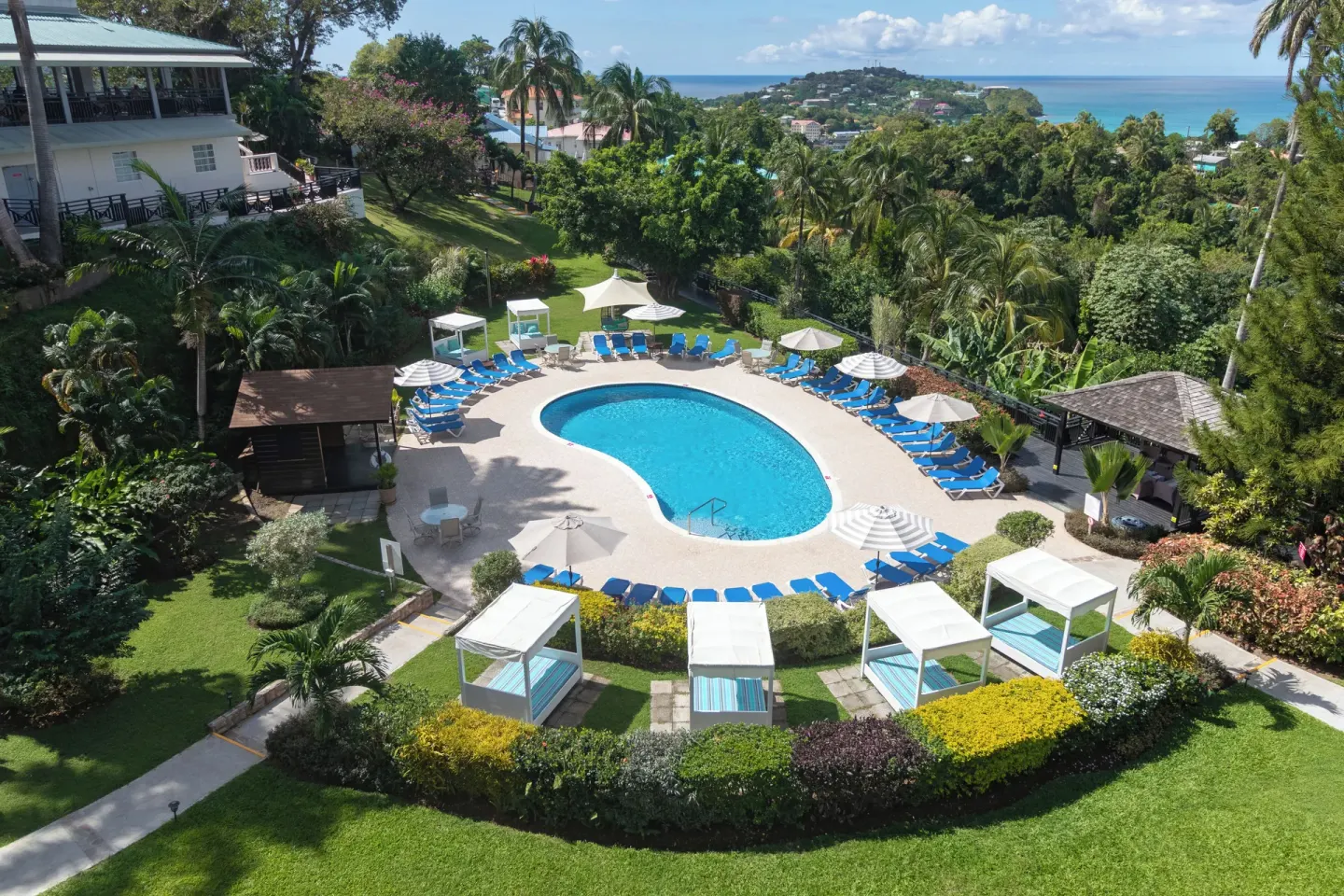 Garden pool with loungers and cabanas at Bel Jou Hotel.
