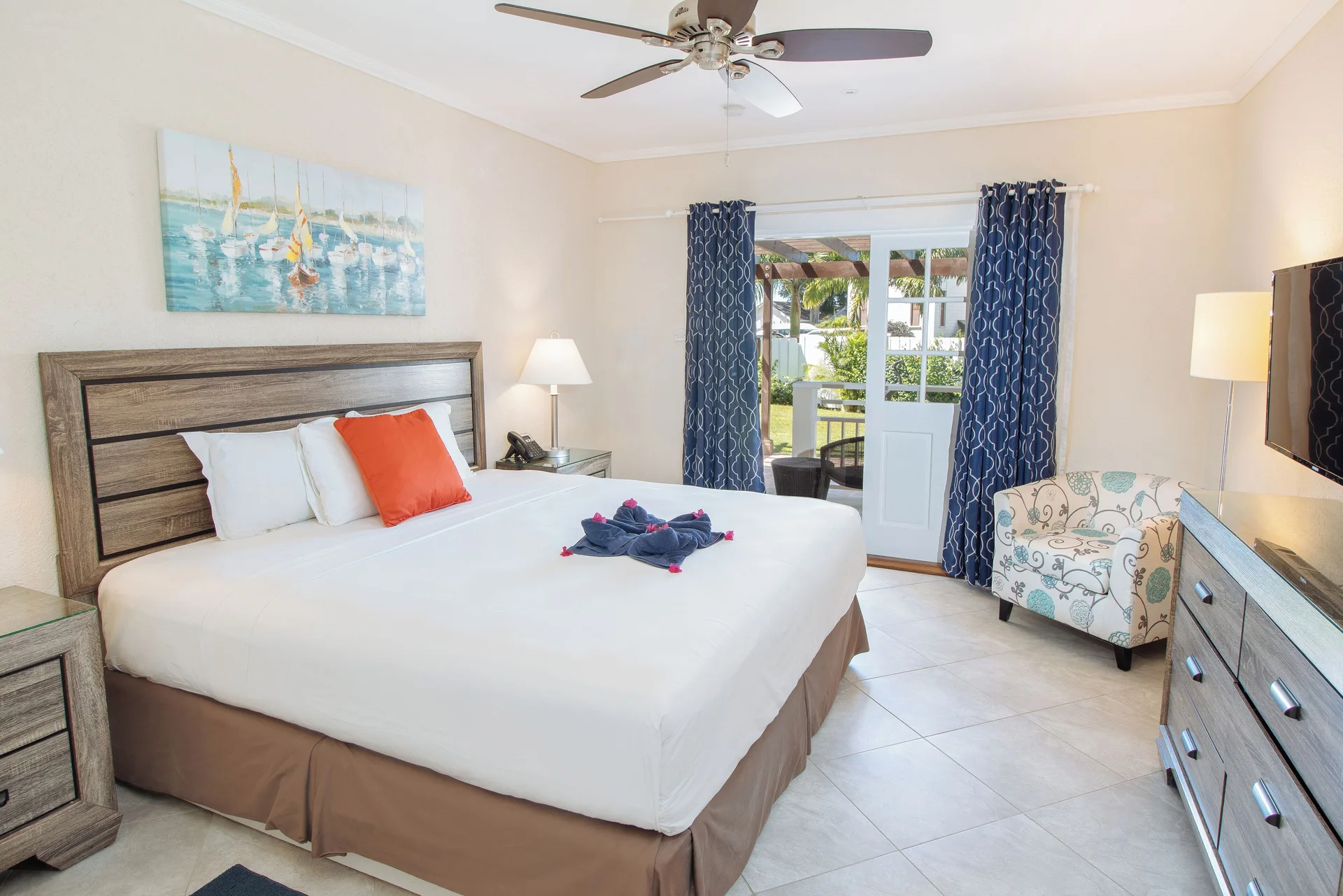 King-bed guest room with open terrace door at Bel Jou Hotel.