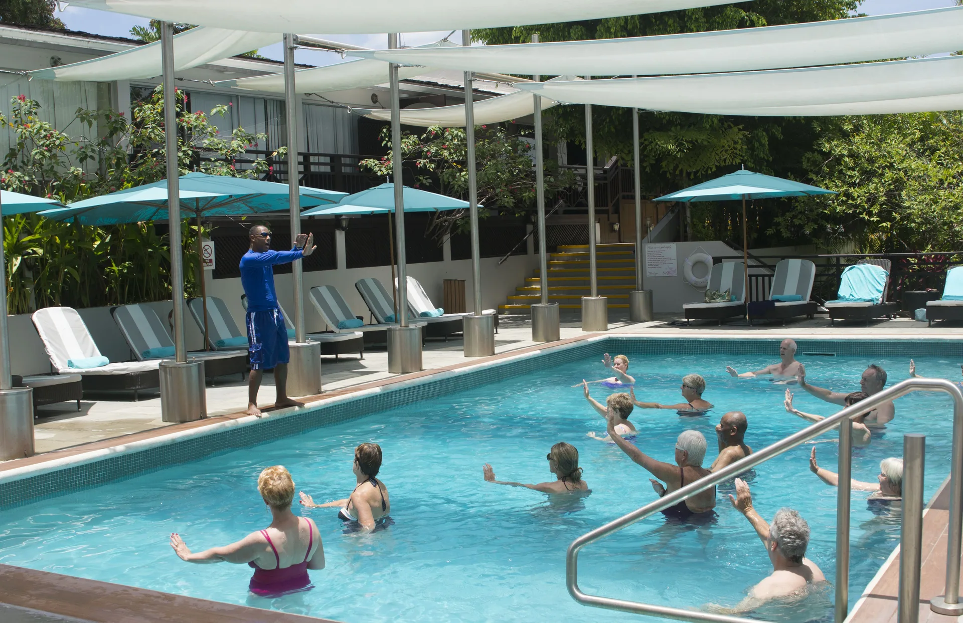 Guests taking a water fitness class in the pool at Bel Jou Hotel.