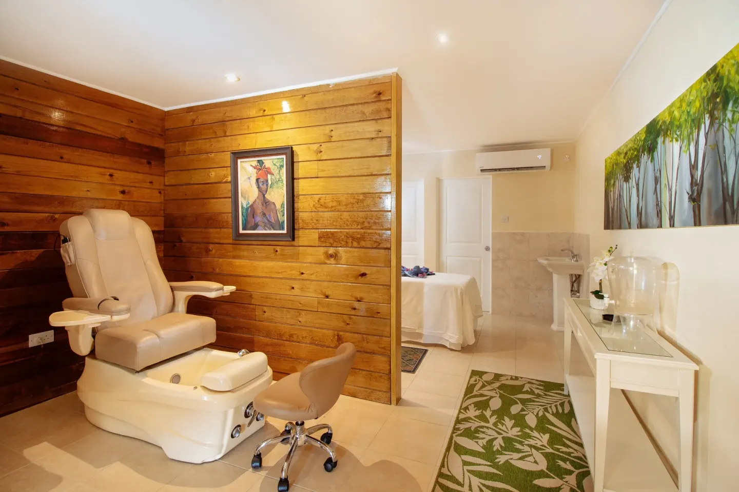 Spa treatment room with pedicure chair and massage bed at Bel Jou Hotel.