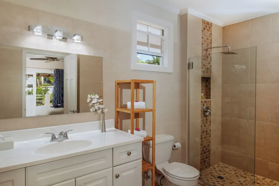 Bungalow garden room bathroom with vanity and walk-in shower at Bel Jou Hotel.