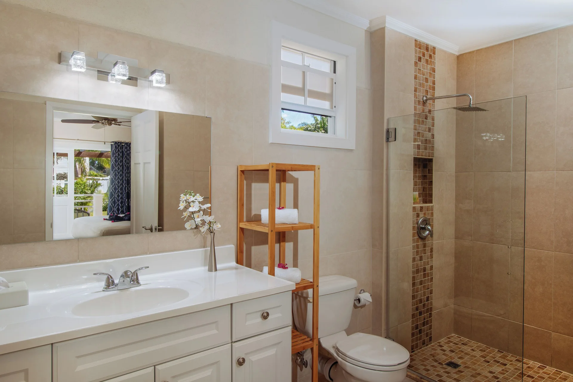 Bungalow garden room bathroom with vanity and walk-in shower at Bel Jou Hotel.