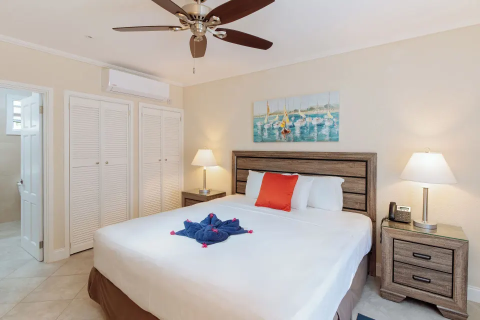 Bungalow garden room with king bed, closets and bedside lamps at Bel Jou Hotel.
