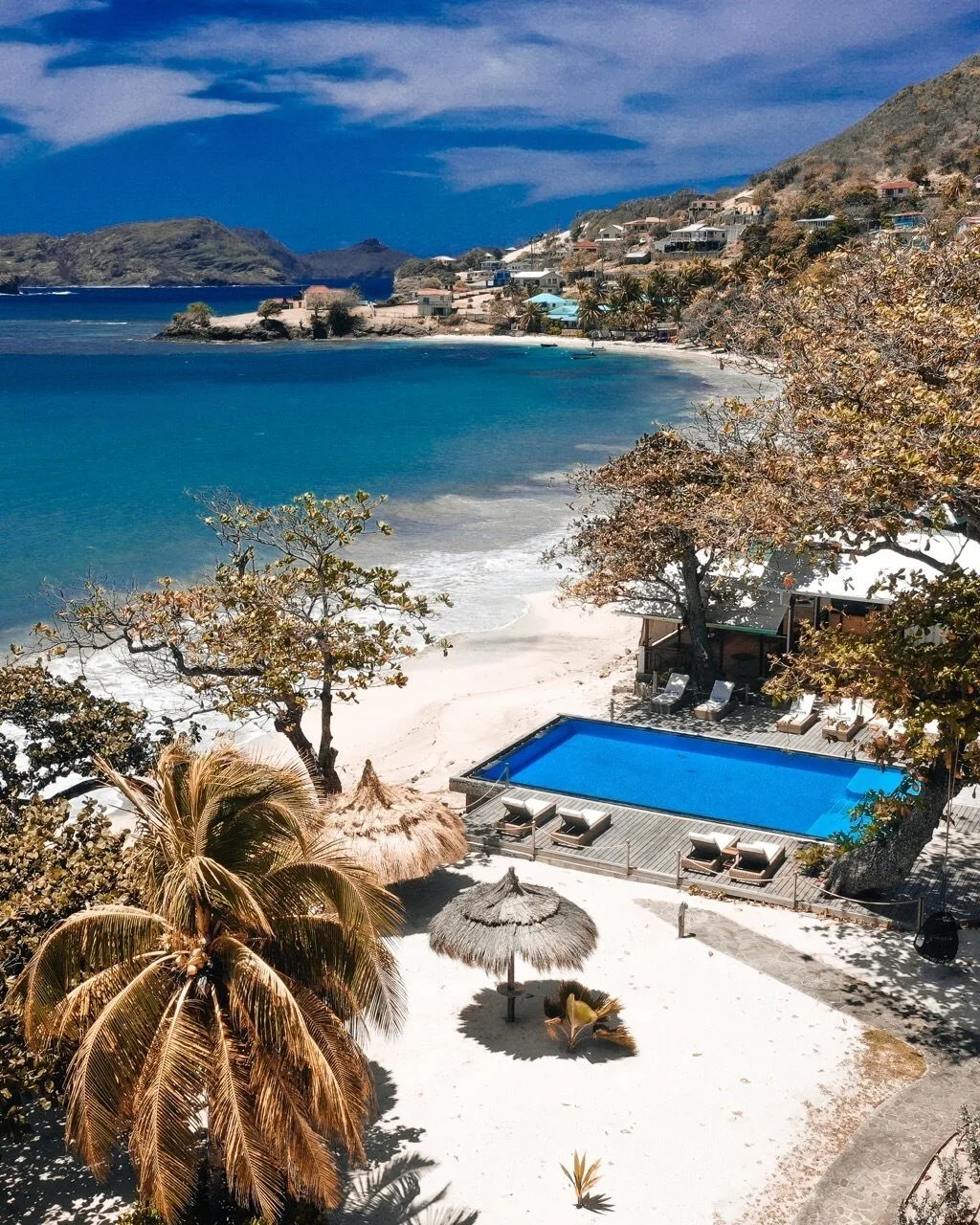 Beachfront pool, palms and bay views at Bequia Beach Hotel.