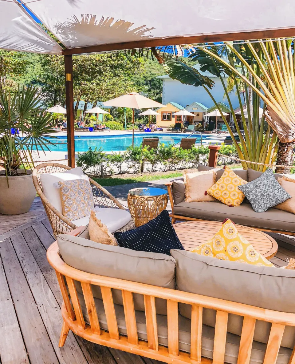Shaded poolside lounge with sofas overlooking the swimming pool at Bequia Beach Hotel.