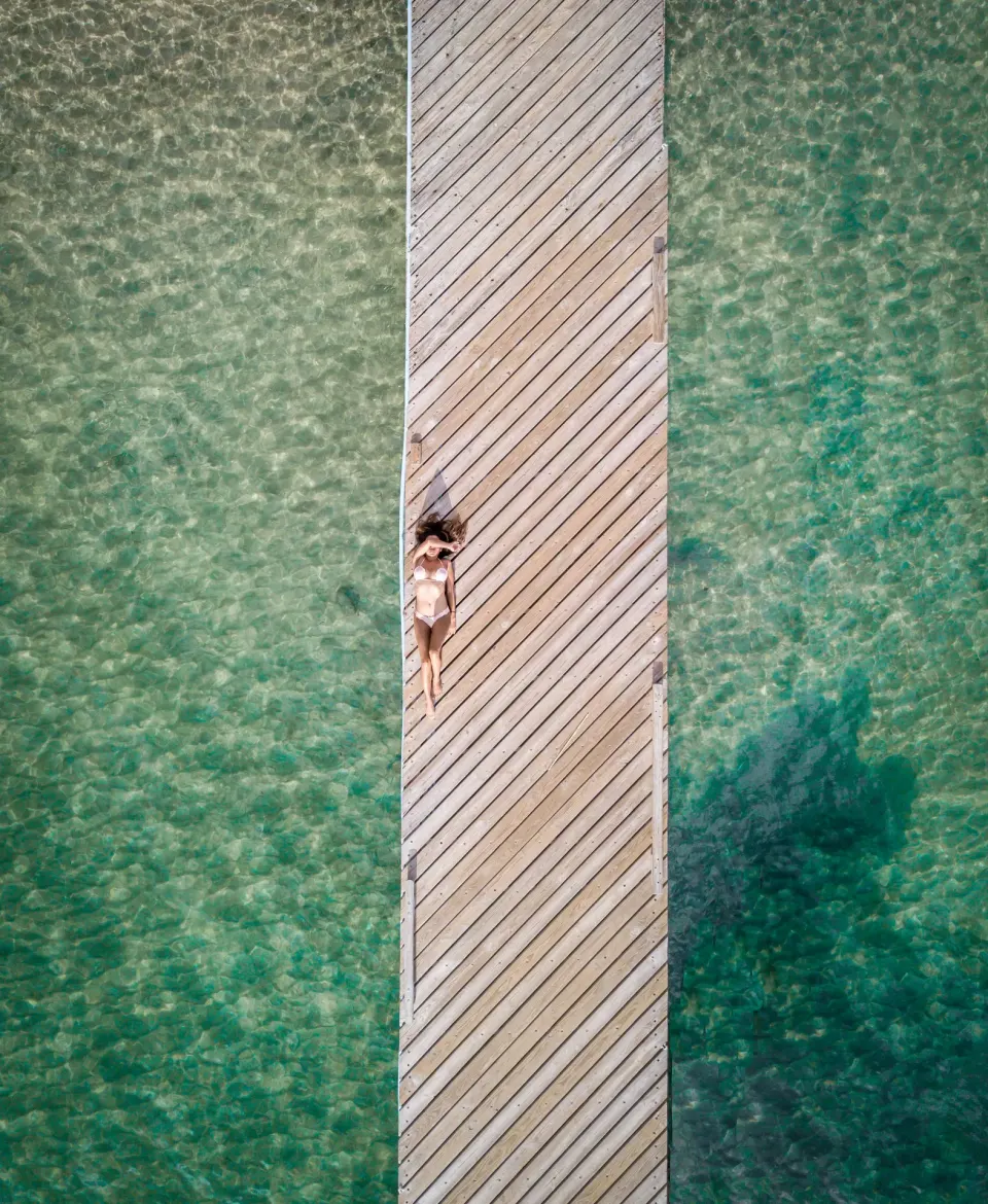 Aerial view of a wooden jetty over clear water at Bequia Beach Hotel.