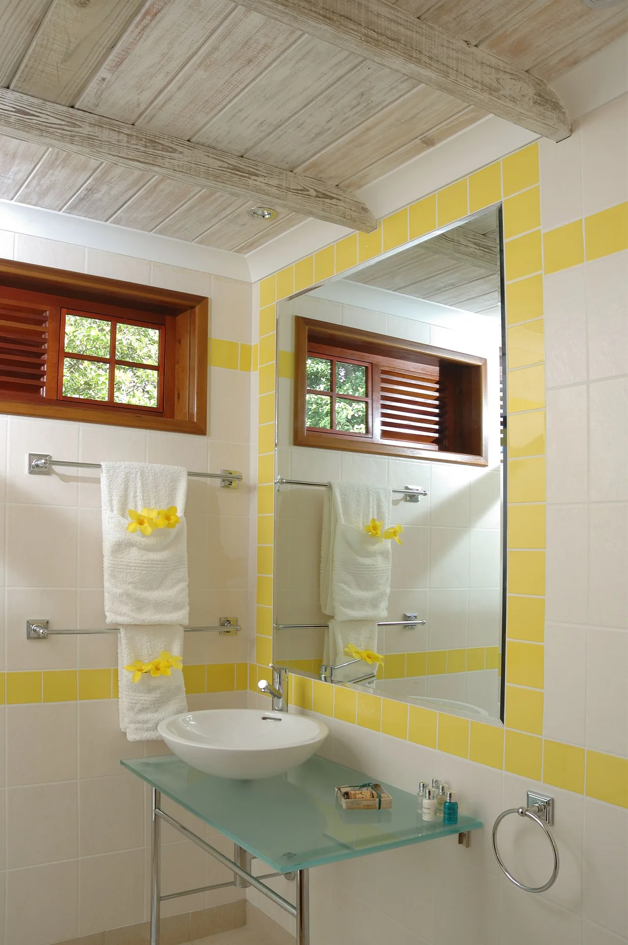 Classic Room bathroom vanity with yellow tile trim at Bequia Beach Hotel.