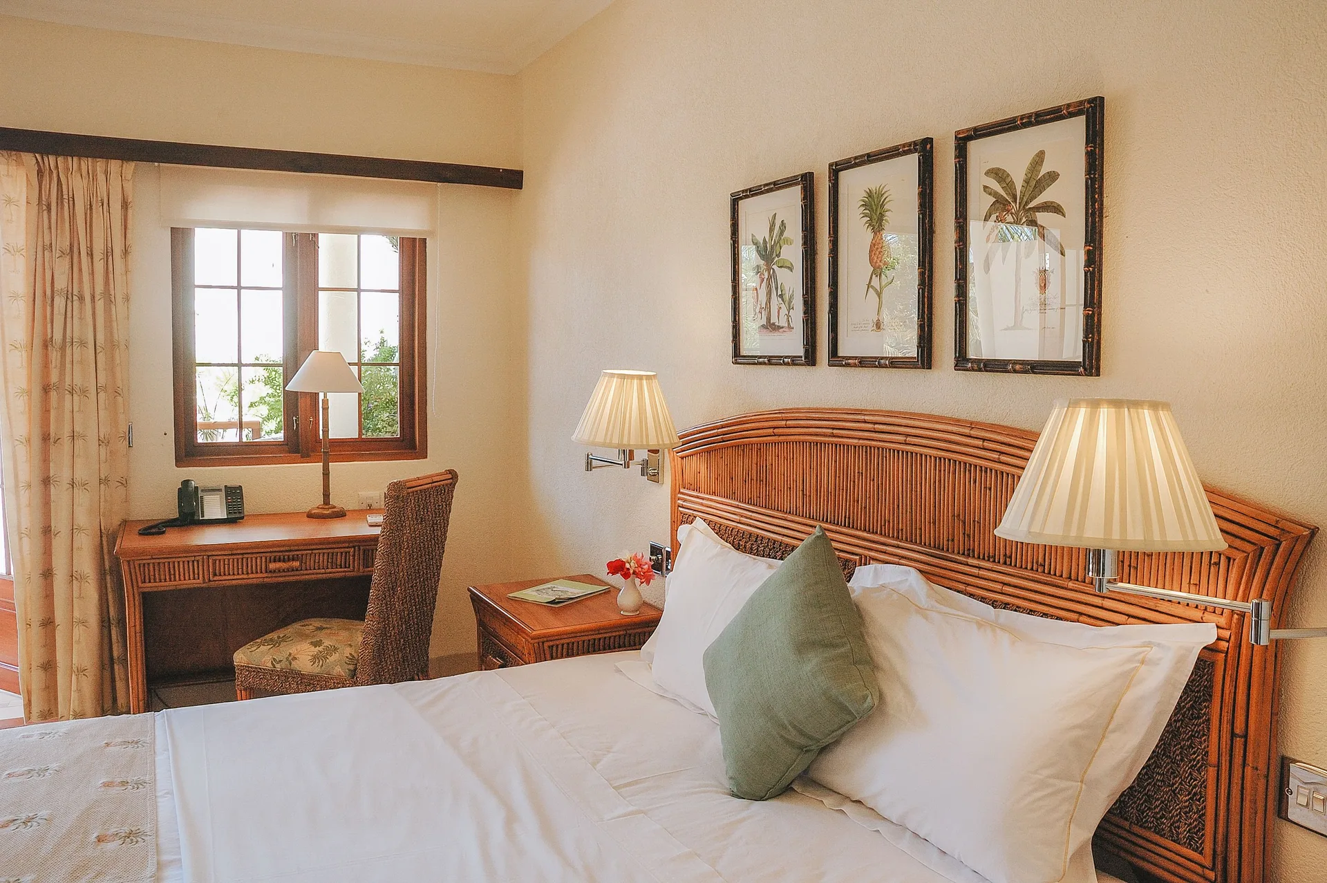Classic Room bed, rattan headboard and writing desk at Bequia Beach Hotel.