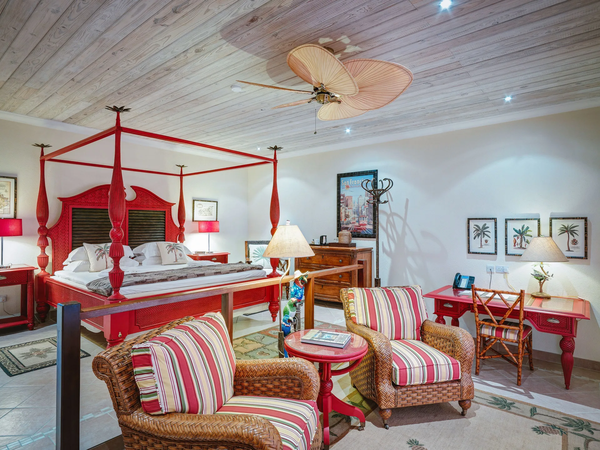 One Bedroom Cottage at Bequia Beach Hotel with four-poster bed, elegant décor, and private terrace overlooking the Caribbean.