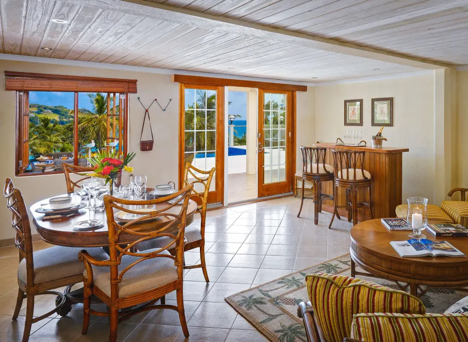 Grand Villa dining and sitting area with ocean-facing doors at Bequia Beach Hotel.