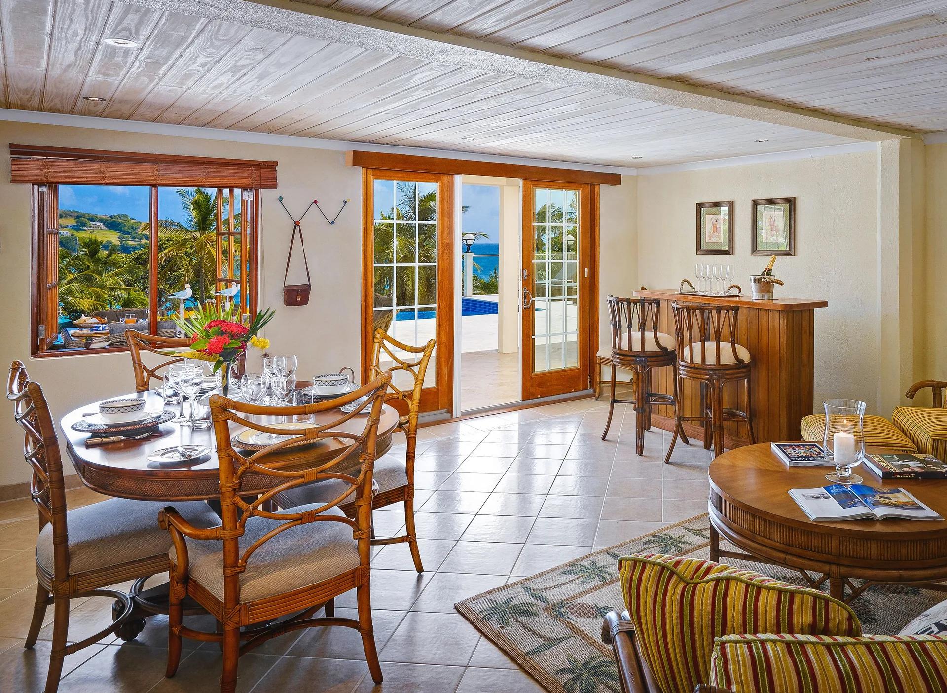 Grand Villa dining and sitting area with ocean-facing doors at Bequia Beach Hotel.