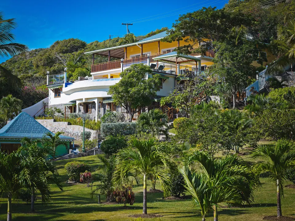 Grand Villa hillside exterior among gardens at Bequia Beach Hotel.