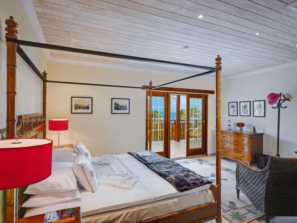 Grand Villa king bedroom with French doors to the balcony at Bequia Beach Hotel.
