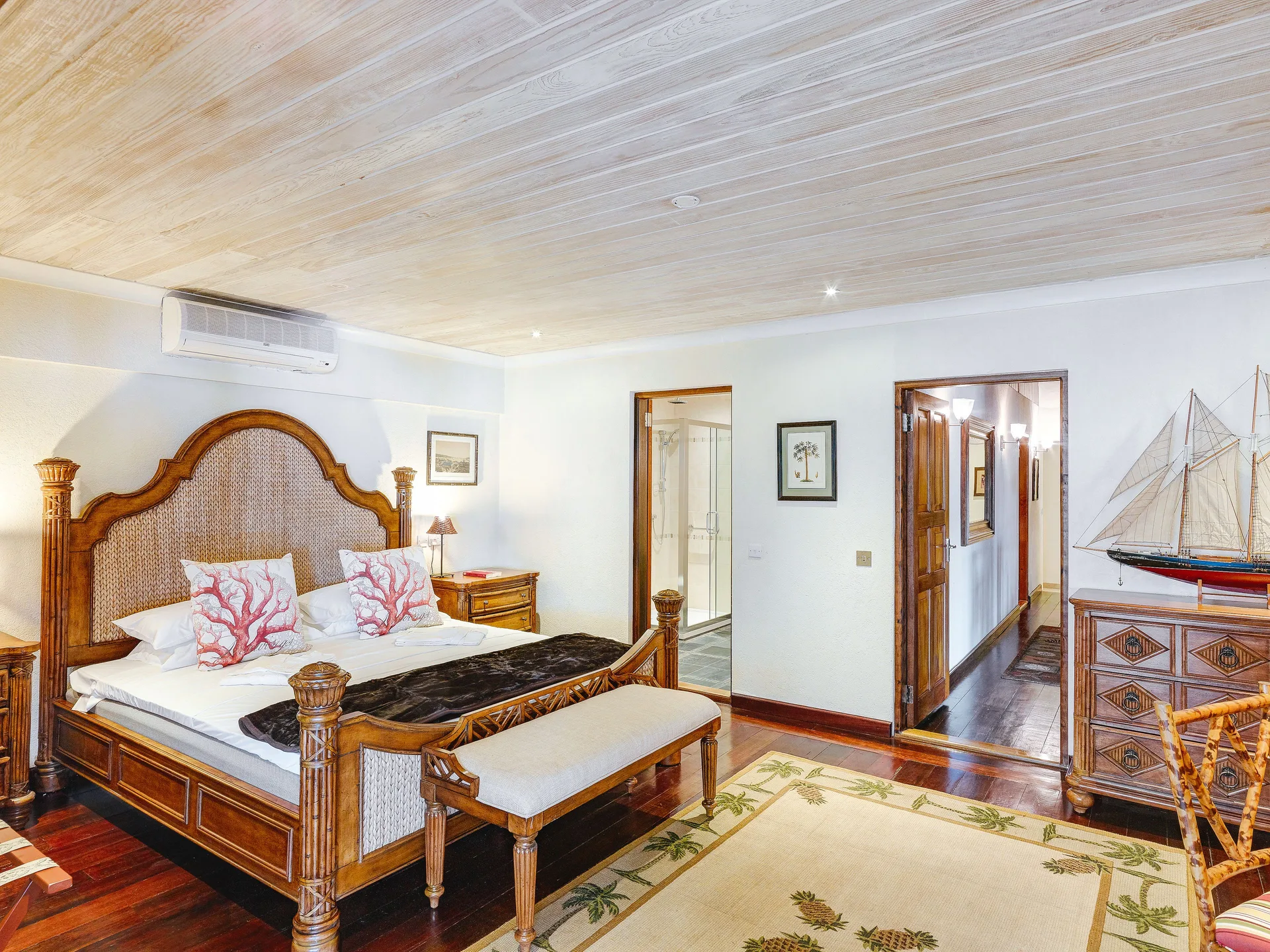 Grand Villa king bedroom with wood furniture at Bequia Beach Hotel.