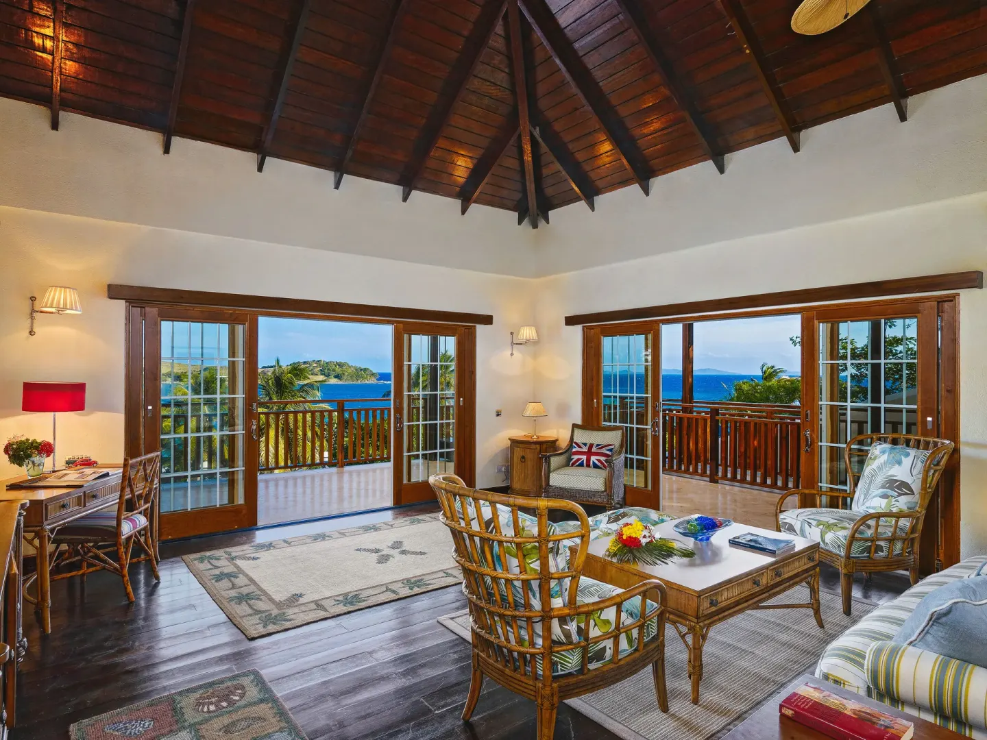 Grand Villa living room with vaulted wood ceiling and sea views at Bequia Beach Hotel.