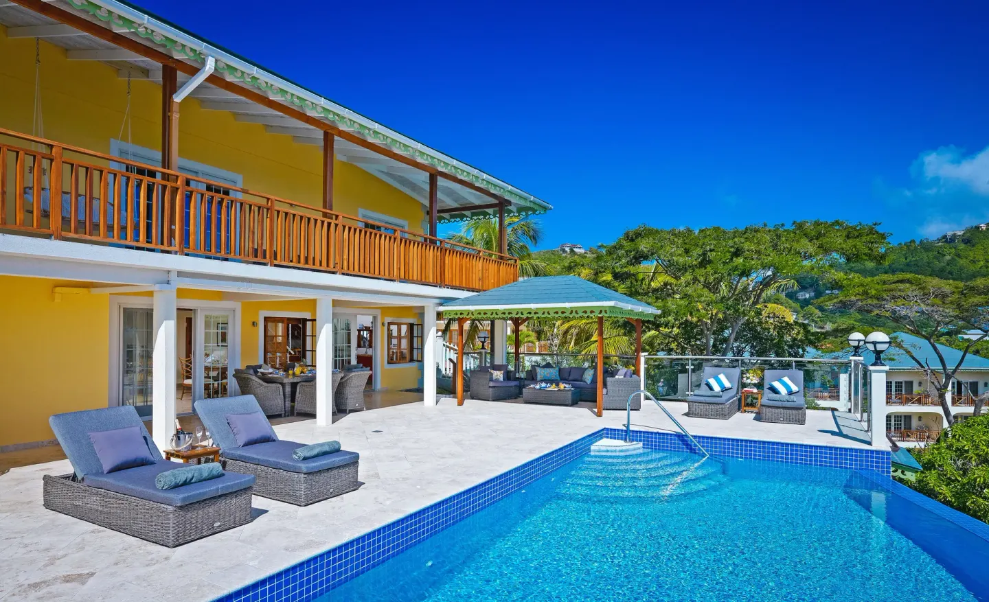 Grand Villa exterior with pool deck and loungers at Bequia Beach Hotel.