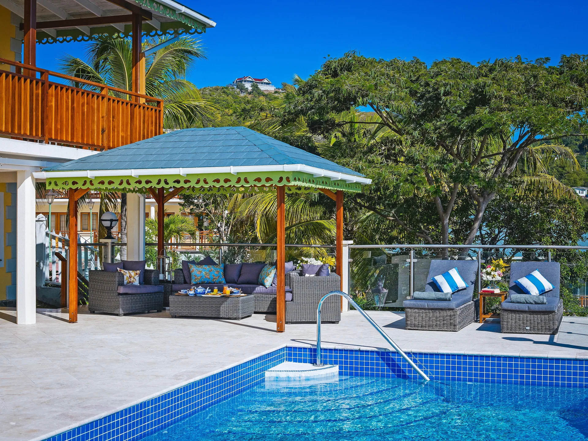 Grand Villa pool terrace with shaded seating at Bequia Beach Hotel.