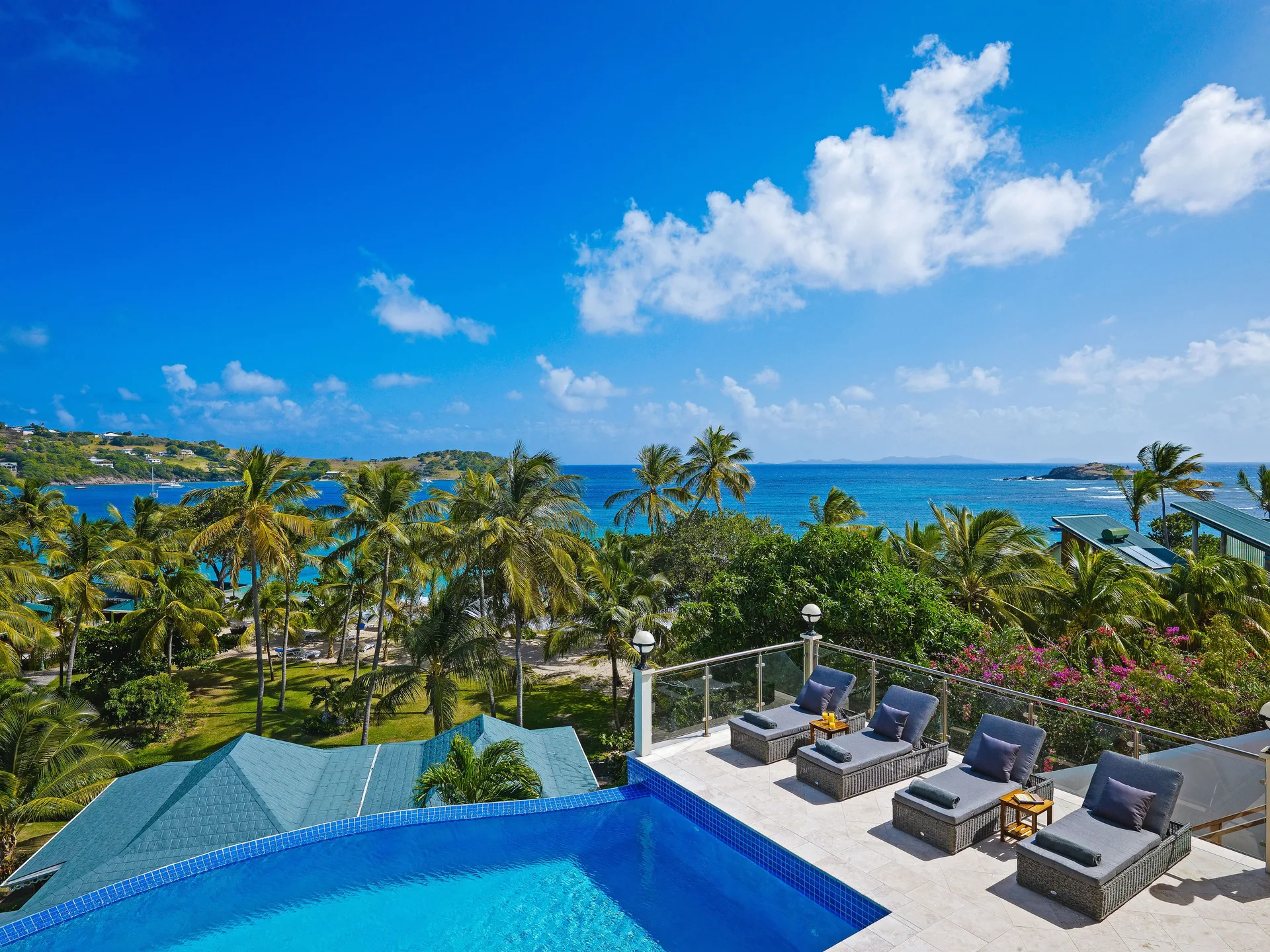 Grand Villa terrace with pool, loungers and ocean view at Bequia Beach Hotel.