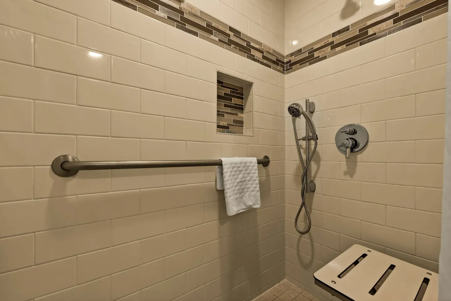 Accessible tiled shower at Best Western The Plaza Hotel Honolulu Airport.